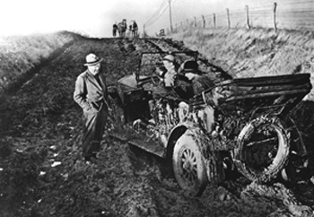"Prior to paved roads, pleasure excursions in the family car could end in disaster in North Carolina. Luckily for this mud-bound convertible and family, the approaching team of horses would pull them free from their prison." Available from NC Museum of History. 
