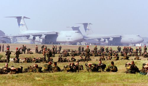 "Soldiers of the U.S. Army's 82nd Airborne Division relax at Pope Air Force Base, N.C., prior to loading into aircraft for an airdrop on May 7, 2000." Image courtesy of the U.S. Department of Defense. " Soldiers of the U.S. Army's 82nd Airborne Division relax at Pope Air Force Base, N.C., prior to loading into aircraft for an airdrop on May 7, 2000." Image courtesy of the U.S. Department of Defense.