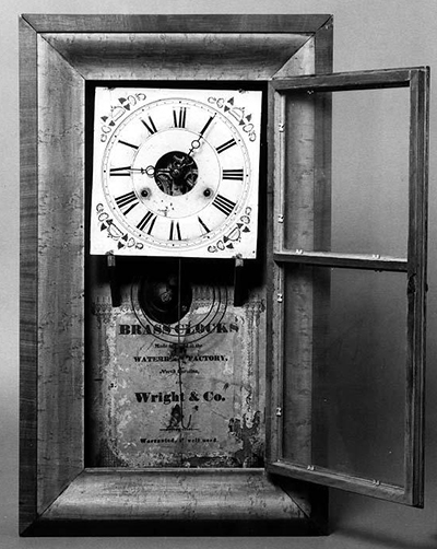 Clock with the label 'Brass clocks made and sold at the Waterbury Factory, North Carolina for Wright & Co.' Circa 1845-1860. Image from the North Carolina Museum of History.
