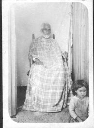 "Washington Lowery, one of the leaders of the Croatoan Indians. Small child in foreground." 1908. Courtesy of the North Carolina Museum of History, access #: 19XX.325.23 .