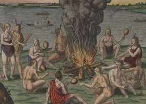 Several half dressed people standing around a large fire. Some of them holding possibly a turkey leg. They are situated next to a body of water that had few boats in the water