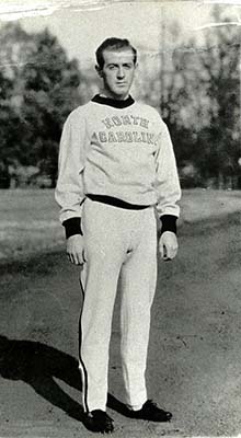 Harry Williamson wearing University of North Carolina track warm-ups. Writing on the back of the photograph indicates it was taken three weeks before the try-outs for the 1936 Olympic games. Harry Williamson competed in the 1936 Olympic games in Berlin, Germany and was inducted into the North Carolina Sports Hall of Fame in 1999. Item 2010.028.010 from the collection of the High Point Historical Society, High Point, NC. Used by permission.