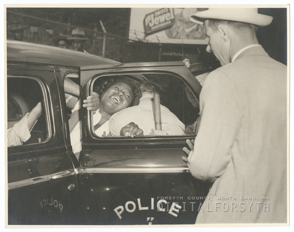 Image of a man being arrested during the protest at Piedmont Leaf Tobacco Company
