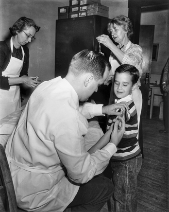 A student receives a polio vaccination on the first day they were administered in North Carolina schools, 18 Apr. 1955. Photograph by Roland Giduz. North Carolina Collection, University of North Carolina at Chapel Hill Library.