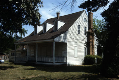 Photograph, Side view, Mallett Rogers House, Fayetteville, Cumberland County, North Carolina. The dwelling, held in the Mallett family from 1778, was occupied by Charles Peter Mallett, father of Charles Beatty Mallett, who moved it from Fayetteville to Eutaw Springs around 1830. Charles Beatty Mallett also resided in the dwelling until he sold it in 1857. Image used by permission from Preservation North Carolina.  Image from Rare & Unique Collections, NCSU Libraries. 