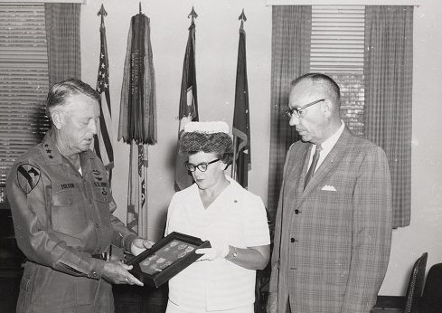 "LTG John J. Tolson, Commanding General XVIII Corps, presents the Silver Star and Bronze Medal posthumously to Glanor Gay Best and Hugh Best Jr., who are receiving the medals on behalf of their deceased son, Hugh E. Best III, who was killed in action in 1969 in the Vietnam War," by C. Gene Tyree DAC at Fort Bragg, North Carolina, published in 1969. Image is presented on East Carolina University's Digital Collection.