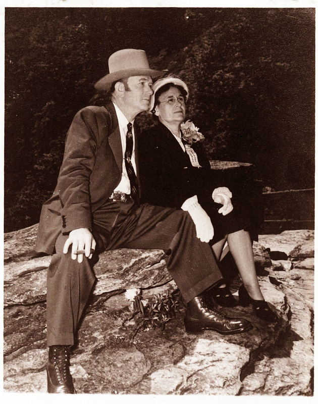 David Williams and Margaret Williams. They are seated on a rock and his arm is around her. They are both wearing formal clothes. Black and white photo.