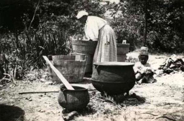 This photo shows a woman washing clothes, somewhere in rural North Carolina. It was taken around 1900 to 1910. Many people in rural areas washed their clothes this way from the 1600s into the 1900s, before they had running water and electricity. This photo comes from the collection of the N.C. Museum of History.