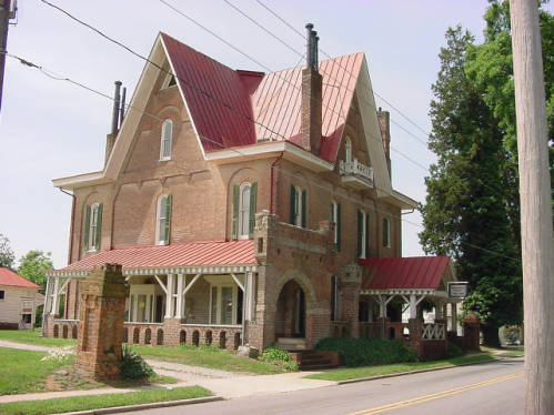 Photograph of "Korners Folly" (pronounced kerners), taken in 2001. Jule Gilmore Korner began construction of the home in 1878 to be a combination of bachelor's quarters, artist studio, office, billiard parlor and ballroom, carriage house and stables, all with a variety of Victorian elements. Image from the NC ECHO project, State Documents Collection, NC Digital Collections.