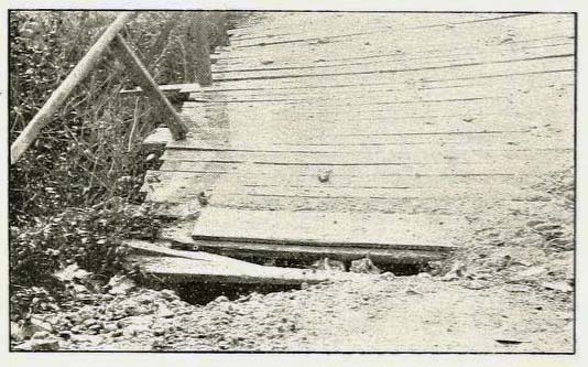 Photograph, ca. 1910, of planks on a bridge in Alabama. Efforts in the 19th to improve road travel for wagons and carriages involved laying planks on roads, similar to planks on bridges. From Henry Varner's Southern Good Roads, February 1911.