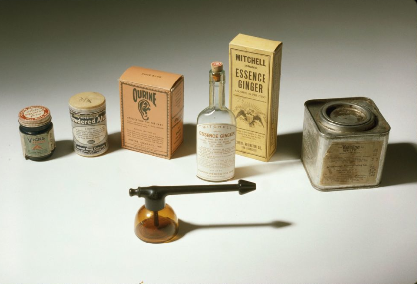 Assorted vintage glass and metal medicinal containers. 