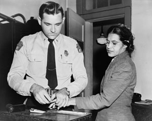 Photo of Rosa Parks being fingerprinted by a police officer