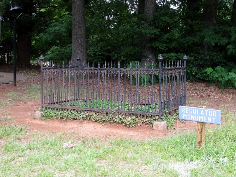 Image of a white marble slab in Hillsborough, NC, marking the spot where six Regulators had been hanged