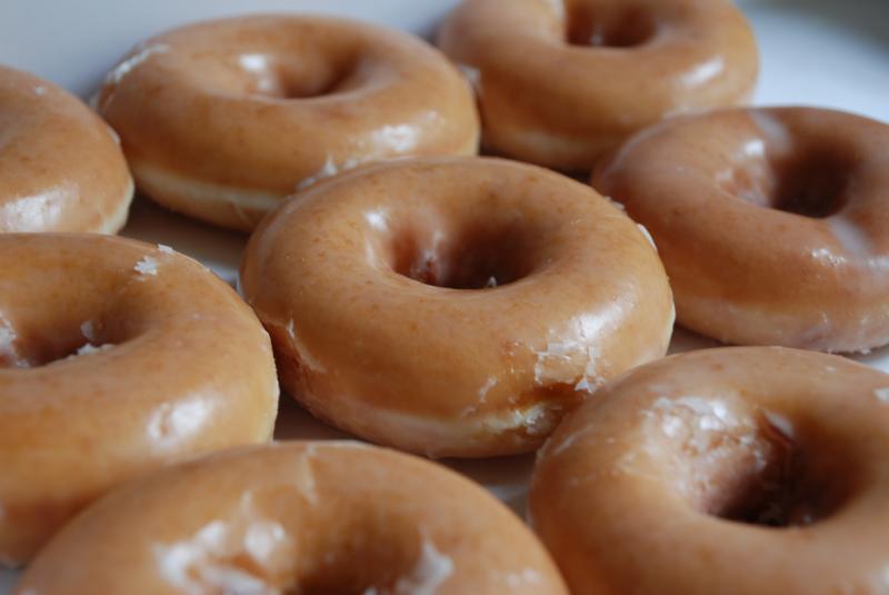 Glazed doughnuts on an assembly line.