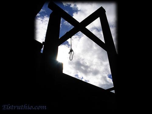 A set of gallows. A cloudy sky is in the background.