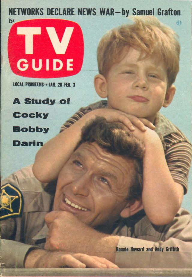 An old magazine with two people on the cover an adult and a child