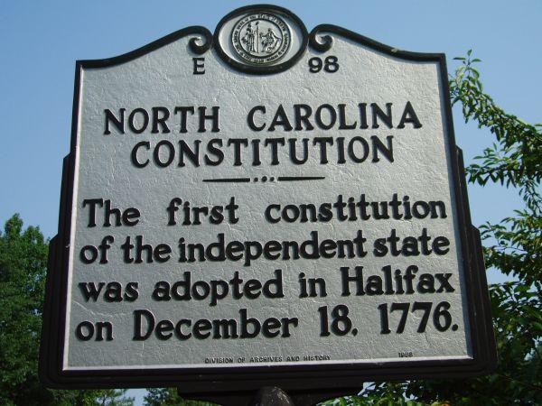 Historical marker: North Carolina Constitution This is an image of the North Carolina Highway historical marker number E-98 located in Halifax County. The text reads: "The first constitution of the independent state was adopted in Halifax on December 18, 1776.