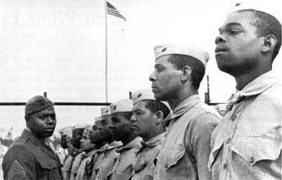 A military commander oversees his corps. They are black.
