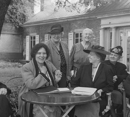This is a photograph of Alice Paul (far left, sitting) with other members of the National Women's Party in 1950.