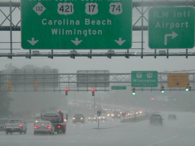 Cars stand in floodwater on a highway.