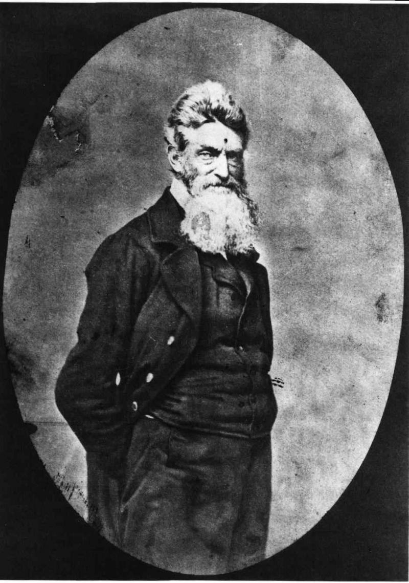 Photograph showing three-quarter length portrait of John Brown, with beard, facing slightly right.