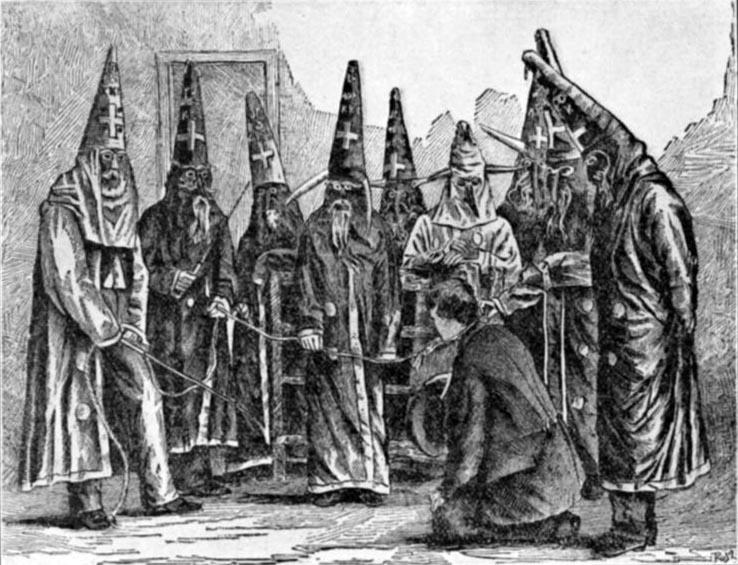 A depiction of Klan costumes. Several men are depicted wearing long robes with pointed hoods which bear crosses and the letters "KKK" on them. 