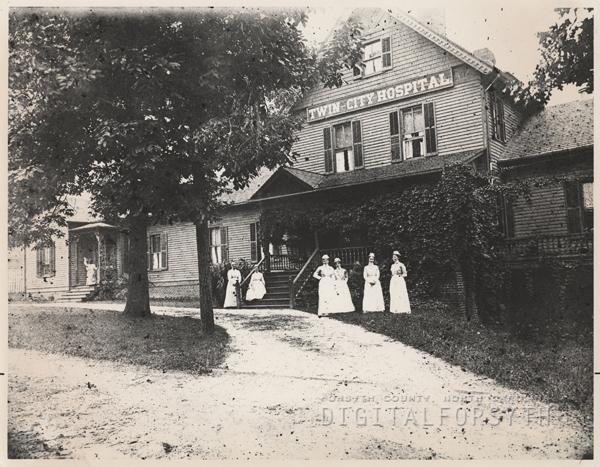 Nurses standing in front of the Twin City Hospital