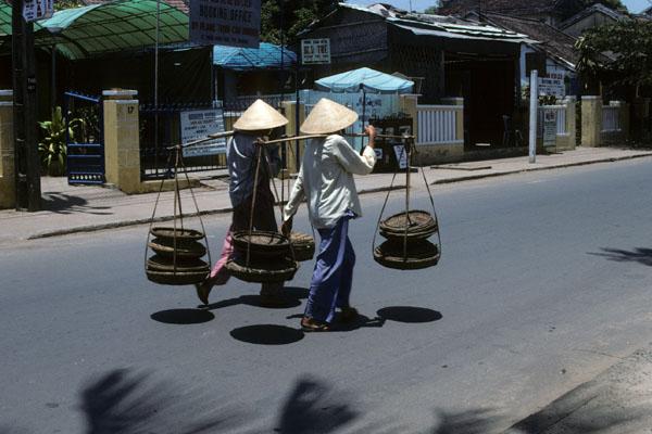 <img typeof="foaf:Image" src="http://statelibrarync.org/learnnc/sites/default/files/images/vietnam_107.jpg" width="600" height="400" alt="Two women carry trays suspended from shoulder poles, Hoi An" title="Two women carry trays suspended from shoulder poles, Hoi An" /> <img typeof="foaf:Image" src="http://statelibrarync.org/learnnc/sites/default/files/images/vietnam_107.jpg" width="600" height="400" alt="Two women carry trays suspended from shoulder poles, Hoi An" title="Two women carry trays suspended from shoulder poles, Hoi An" />