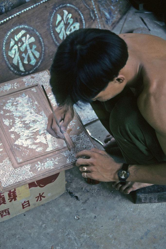 <img typeof="foaf:Image" src="http://statelibrarync.org/learnnc/sites/default/files/images/vietnam_111.jpg" width="683" height="1024" alt="Man applies inlay designs to a wood plaque, Hoi An" title="Man applies inlay designs to a wood plaque, Hoi An" />