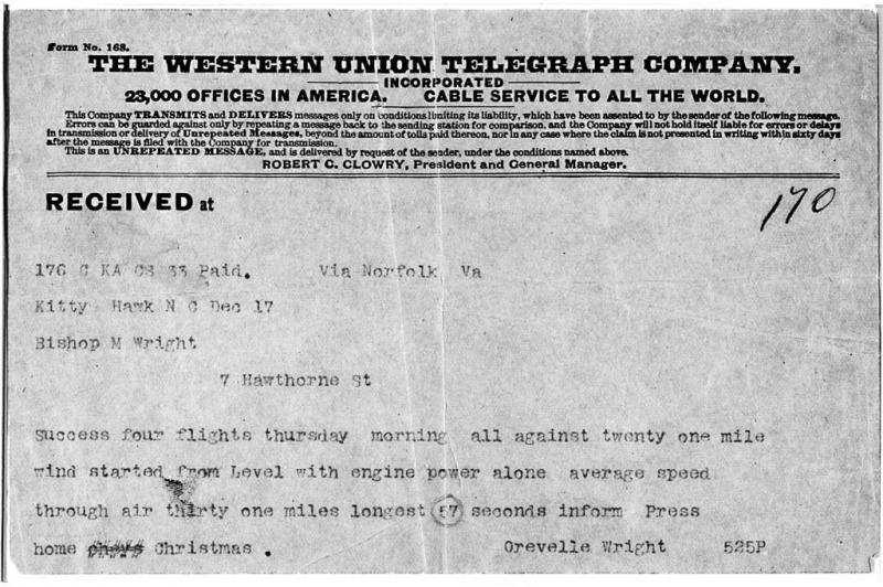 Printed words on a telegram explain the first flight. Black and white.