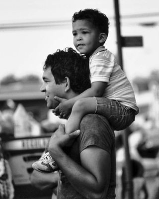 Lumbee father and son watching a homecoming parade