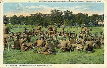 Postcard depicted soldiers at leisure in a grassy area.