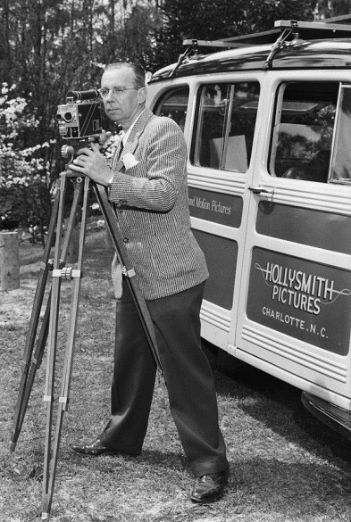 Photograph of Holly Smith posing with camera, circa 1940s-early 1950s. Image from the Hugh Morton Collection of Photographs and Films, North Carolina Collection Photographic Archives, Wilson Library, University of North Carolina at Chapel Hill.