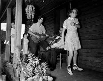 Asheville Mountain Music Festival Asheville August 1938, photo taken by Baker. The musicians are Osey and Ernest Helton. Conservation and Development Department, Travel and Tourism Division Photo Files, North Carolina State Archives, call #: ConDev1424C. 