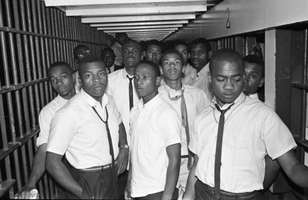 African American men protesters crowded into a jail cell.