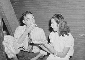 &quot;  Many parents and young people from the school and nearby communities attend the pie and box supper, given by the school to raise money for additional repairs and supplies. Each box or pie is auctioned off to the highest bidder, sometimes bringing a good deal, since the girl's &quot;boyfriend&quot; usually wins and has the privilege of eating it with her afterwards.&quot; 1944. Image courtesy Library of Congress.