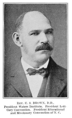 Black and white photograph of a man wearing a dark colored suit with a white shirt and dark bowtie. Text below reads "Rev C.S. Brown, D.D., President Waters Institute. President Lott-Cary Convention. President Educational And Missionary Convention of N.C." 