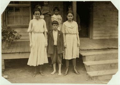 The three on the ground work in the Cannon Mills, Concord, N.C. The boy "Otie Honeycott" (his mother could not spell his name) said he had been doffing two years in the Cannon Mill, Concord, NC, 1912. 