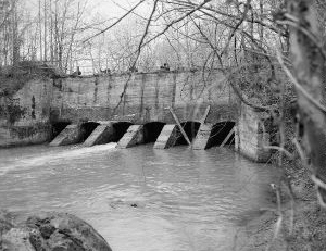 "View looking west at Sluice Gates at dam from north bank of Deep River- Lockville Hydroelectric Plant, Deep River, 3.5 miles upstream from Haw River, Moncure, Chatham County, NC." Image courtesy of Library of Congress; call #: HAER NC,19-MONC,1--6. 