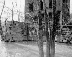 "View showing east elevation of powerhouse and masonry retaining walls- Lockville Hydroelectric Plant, Deep River, 3.5 miles upstream from Haw River, Moncure, Chatham County, NC." Image courtesy of Library of Congress, call #: HAER NC,19-MONC,1--16.