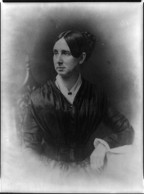 Dorothea Dix. Black and white portrait. She is facing left and seated in chair. Her hair is parted in the middle.