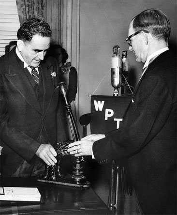 Photograph of Gov. Kerr Scott passing the Great Seal of NC to Gov. William Umstead, January 1953. Item H.1966.109.14 from the North Carolina Museum of History. Used courtesy of the Department of Cultural Resources. Photograph of Gov. Kerr Scott passing the Great Seal of NC to Gov. William Umstead, January 1953. Item H.1966.109.14 from the North Carolina Museum of History. Used courtesy of the Department of Cultural Resources.