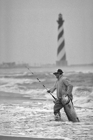 Fishing in the surf near Cape Hatteras Lighthouse. Photograph courtesy of North Carolina Division of Tourism, Film, and Sports Development.