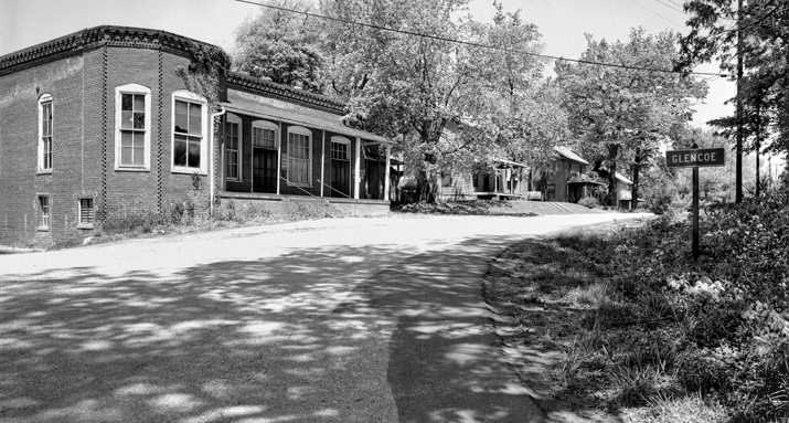 The company store (left) and houses along a street in Glencoe, 1978. Courtesy of North Carolina Office of Archives and History, Raleigh.