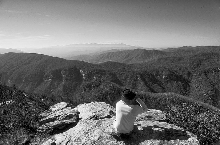 A hiker surveys the horizon from the edge of Linville Gorge. Photograph courtesy of North Carolina Division of Tourism, Film, and Sports Development.