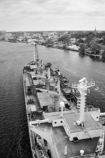 A cargo-laden barge moves up the Cape Fear River to the port of Wilmington. Photograph by Charles E. Jones. North Carolina Department of Transportation.