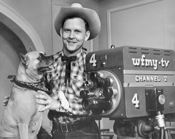 Jim Tucker, star of the Old Rebel-Pecos Pete Show, and his boxer, Troubles, 1958. The popular children's program on WFMY-TV in Greensboro was locally produced. Photograph by WFMY-TV. North Carolina Collection, University of North Carolina at Chapel Hill Library.