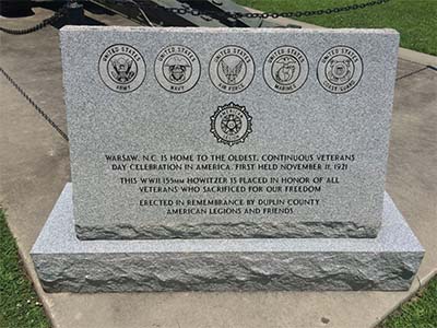 Photograph of the granite monument at the Duplin County Veterans Howitzer monument, Warsaw, N.C. The marker acknowledges the first annual occurrence of the Warsaw parade on November 11, 1921. Photograph courtesy of Commemorative Landscapes of North Carolina.