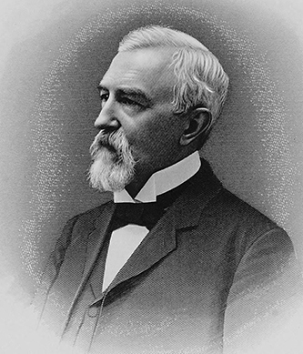 Engraving of Hadley. It is greyscale. He has a serious expression, and has a medium beard and mustache. He is also wearing a black suit. 