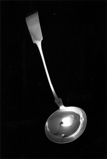 Photograph of a sterling silver punch ladle with down-turned, fiddle style handle made by Lemuel Lynch.  Item H.1982.221.2 from the collections of the North Carolina Museum of History. Used courtesy of the North Carolina Department of Cultural Resources. 